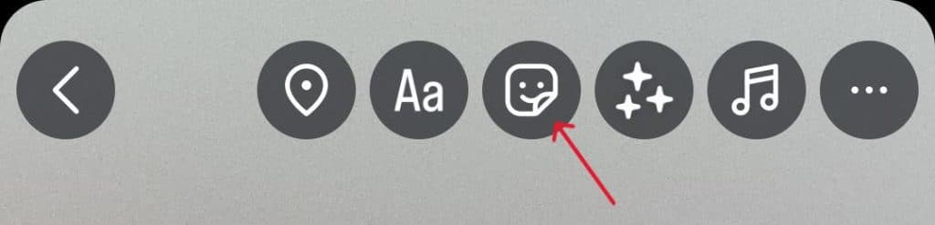 Instagram Story editing toolbar with a red arrow pointing to the sticker icon used to add music or effects to a Story.